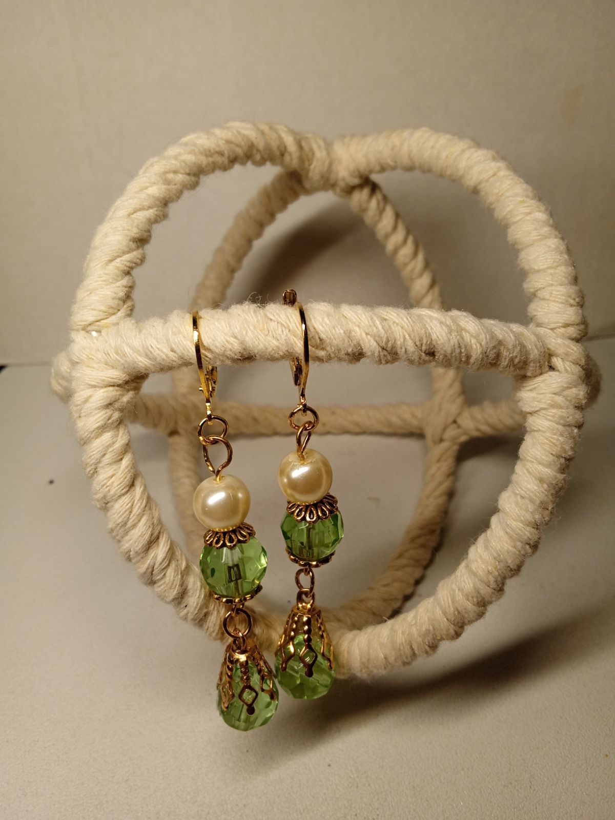 Dangle earrings with soft green crystal glass beads.