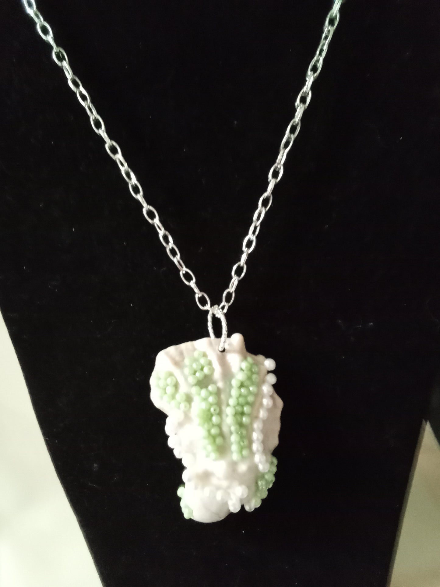 Green and white ornated oyster pendant