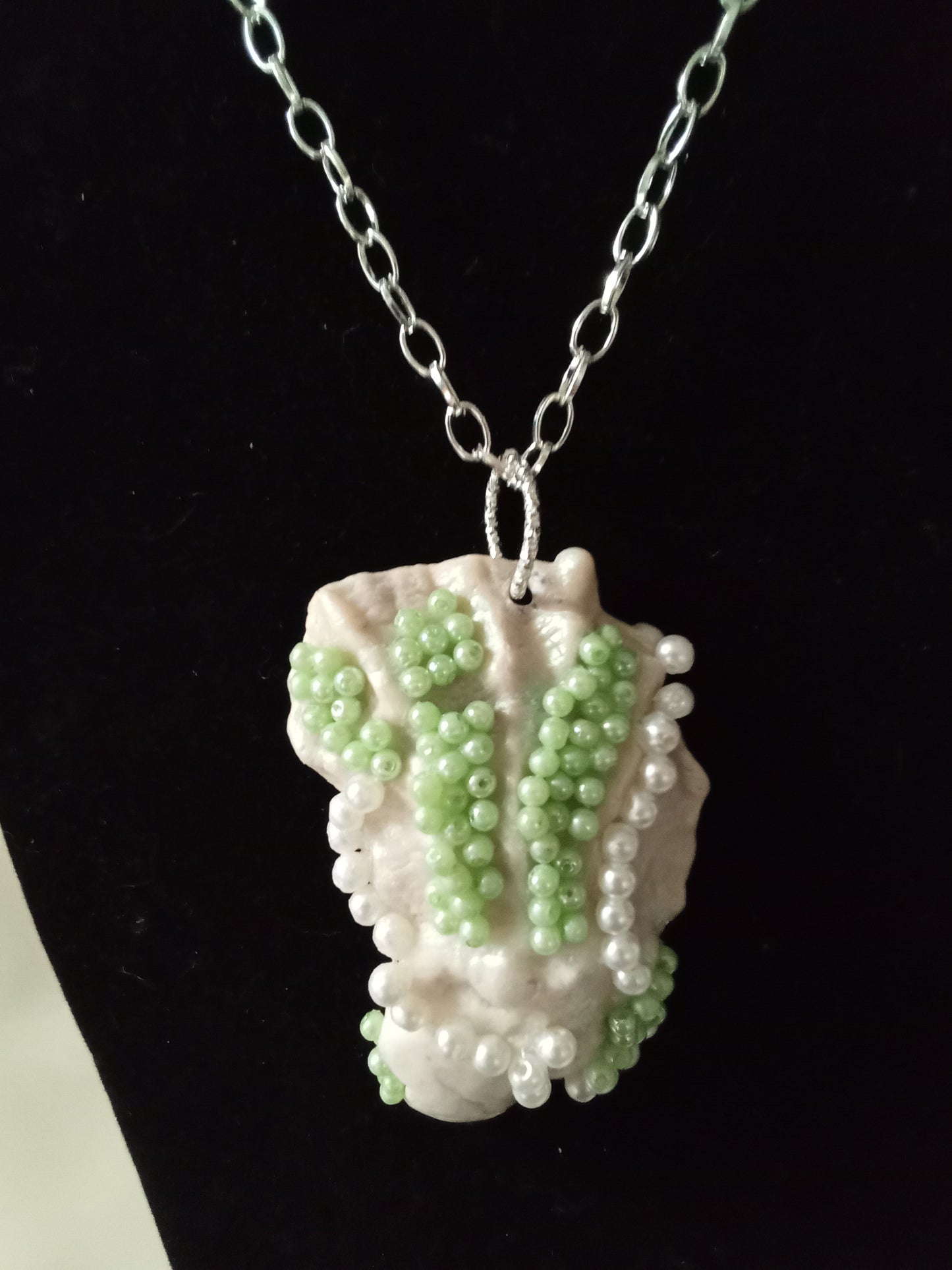 Green and white ornated oyster pendant