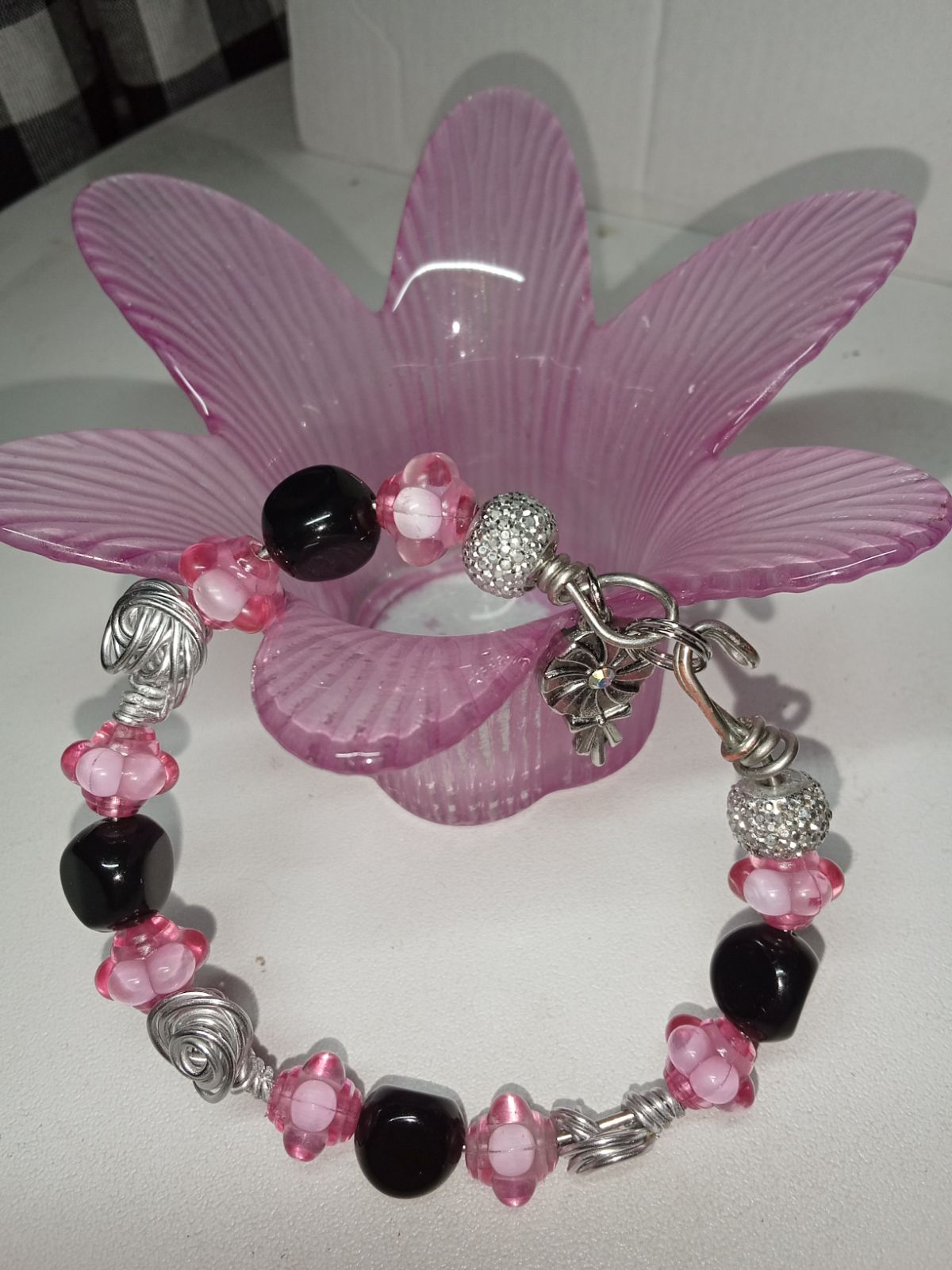 Wire bracelet with bumpy pink beads, black shiny dimensional and silver disco beads.