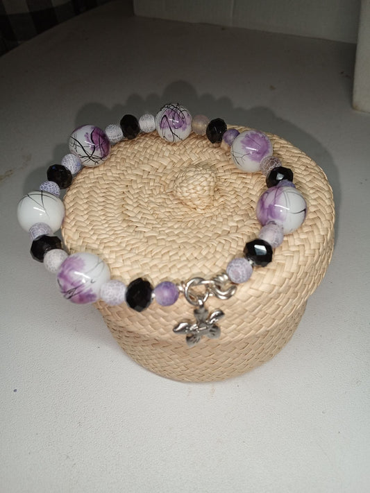 Wire bracelet with interesting ink drizzle look of soft lavender and black on white base.